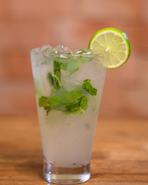 A Cold Drink with Lime Slices and Mint 