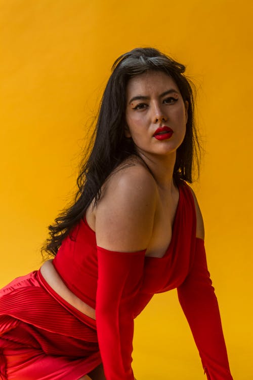 Woman Posing in Studio against Yellow Background