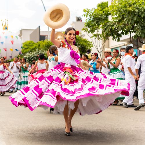 Free Joyful dancers in traditional attire celebrate Mexican culture during Oaxaca's colorful street parade. Stock Photo