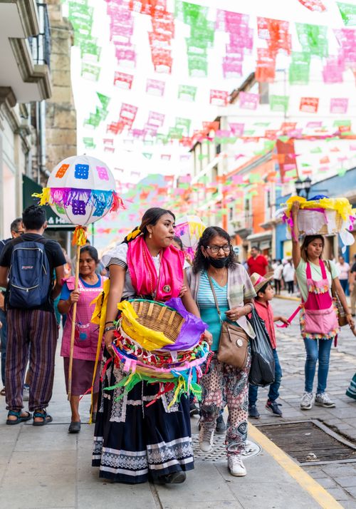 Free Colorful street parade during the Guelaguetza festival in Oaxaca City, showcasing traditional Mexican culture. Stock Photo