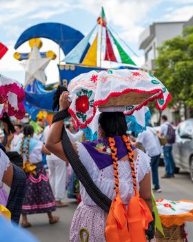 Colorful celebration of Mexican culture at the Guelaguetza festival in Oaxaca, showcasing traditional clothing and festive spirit.
