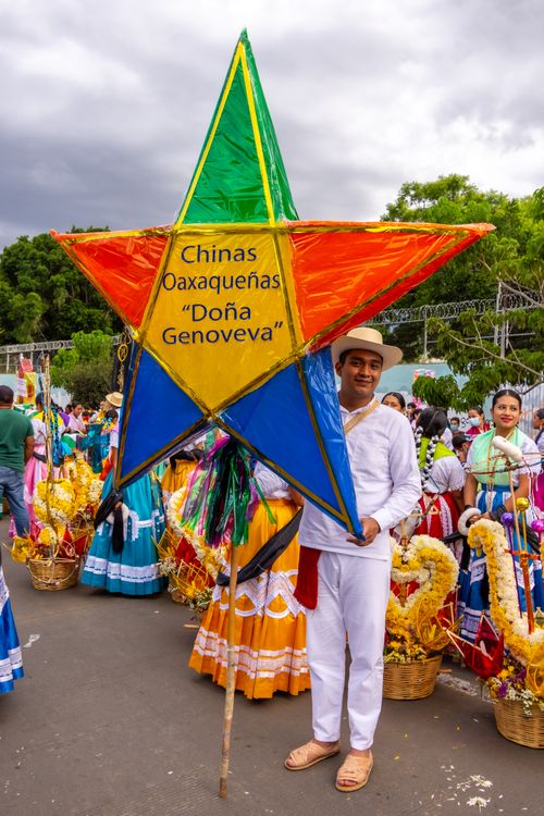 People Wearing Colourful Festival Clothing, and a Man Standing with a Star Decoration Free Stock Photo People Wearing Colourful Festival Clothing, and a Man Standing with a Star Decoration Free Stock Photo