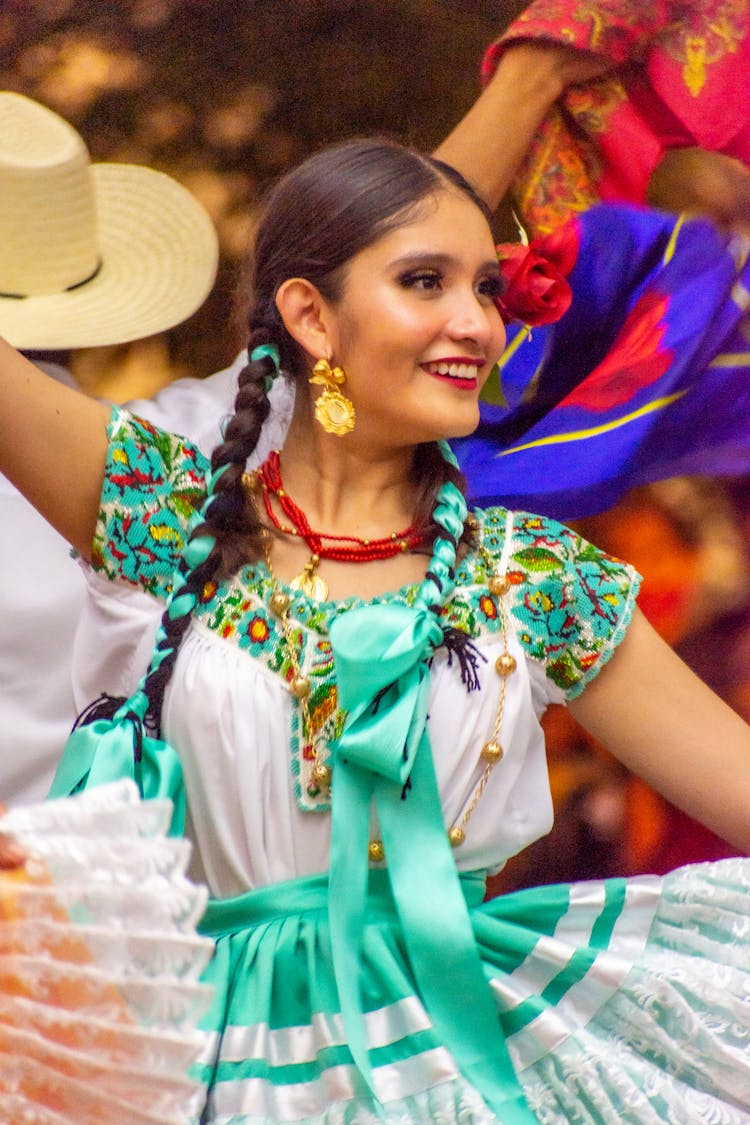 Closeup Of A Woman Dancing In A White And Turquoise Folklore Dress