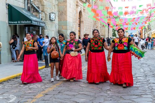 Free Women in colorful traditional clothes at a Mexican street festival in Oaxaca. Stock Photo
