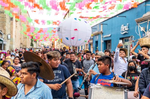 Free Colorful parade celebrating Mexican culture with traditional music and clothing in Oaxaca. Stock Photo