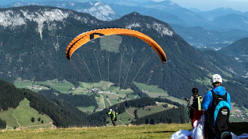 View of People Paragliding in Mountains 