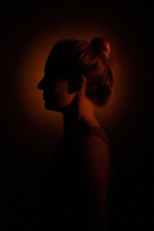 Silhouette of Woman Head in Spotlight