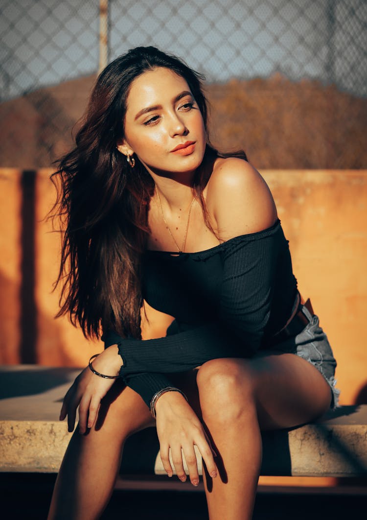 Woman Sitting On Stone Bench