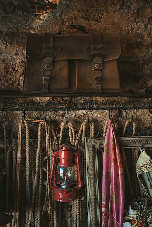 A Vintage Briefcase and Lantern Hanging on the Wall 