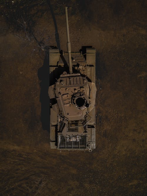 Dark Aerial Footage of a Tank on a Field