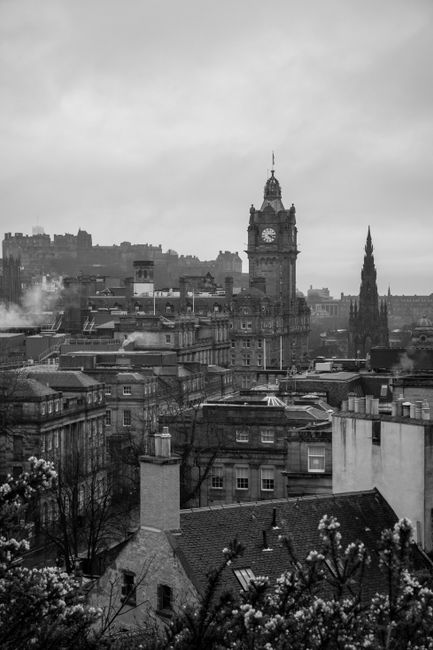 Explore the atmospheric skyline of Edinburgh, featuring the iconic clock tower in a stunning black and white panorama.