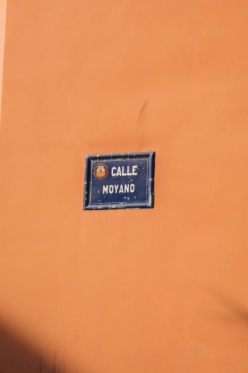 Moyano Street Board on Orange Wall