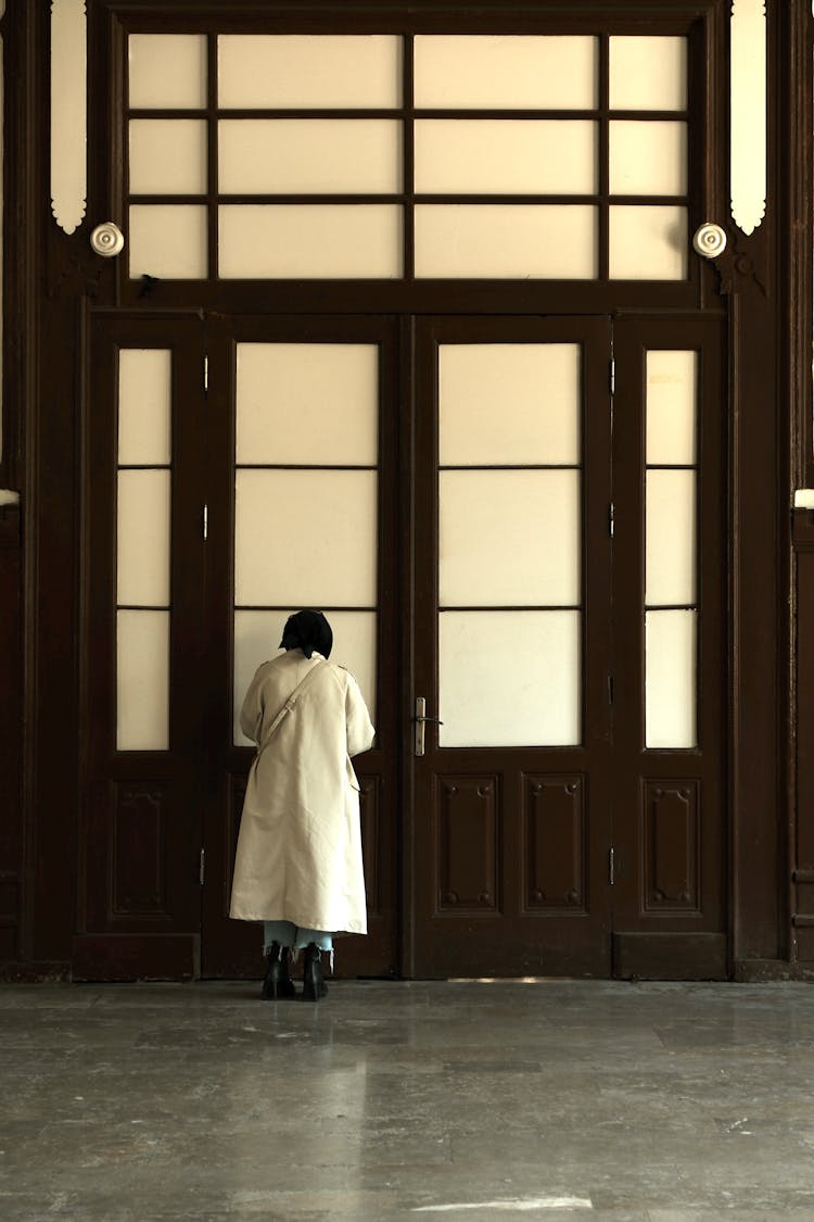 Woman In Coat By Door