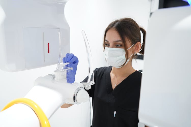 Doctor Cleaning A Dental Prosthesis