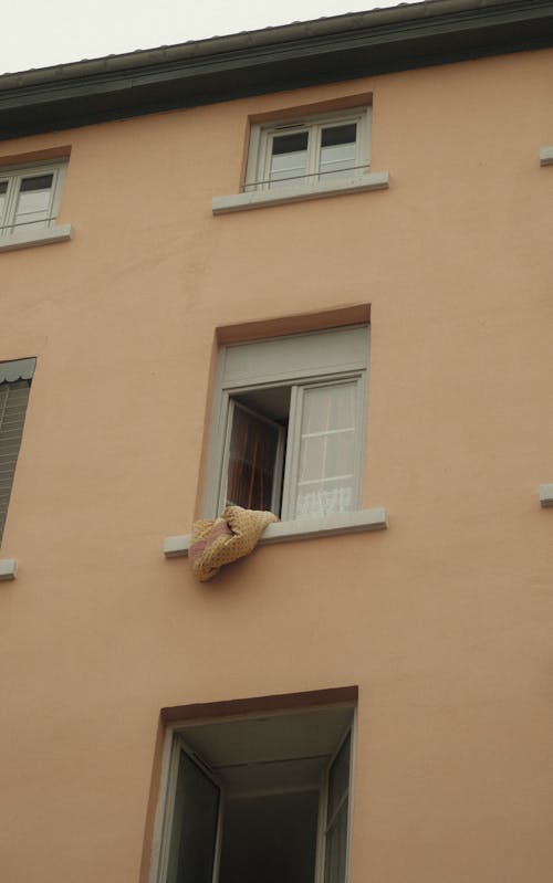 Duvet Hanging Out of Open Apartment Window