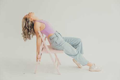 Blonde Woman Leaning on Chair