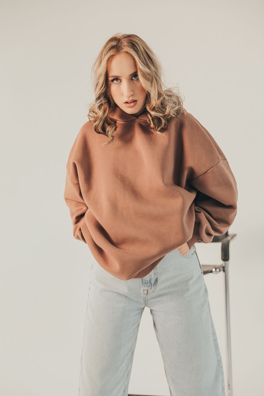 Portrait of a woman posing in a studio wearing casual fashion