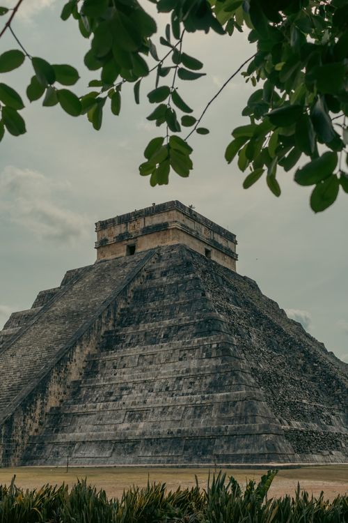 Free Explore the ancient structure of Chichen Itza under a cloudy sky. Stock Photo