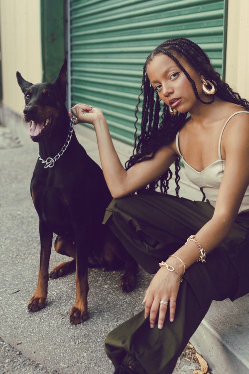 Free Elegant woman with Doberman in city street, showcasing fashion and companionship. Stock Photo