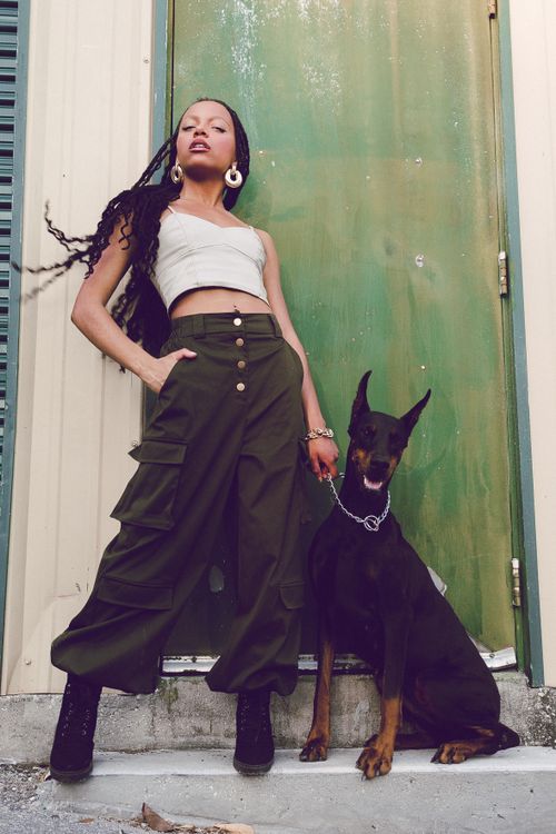 Free A stylish woman poses confidently with her Doberman in an urban setting. Stock Photo