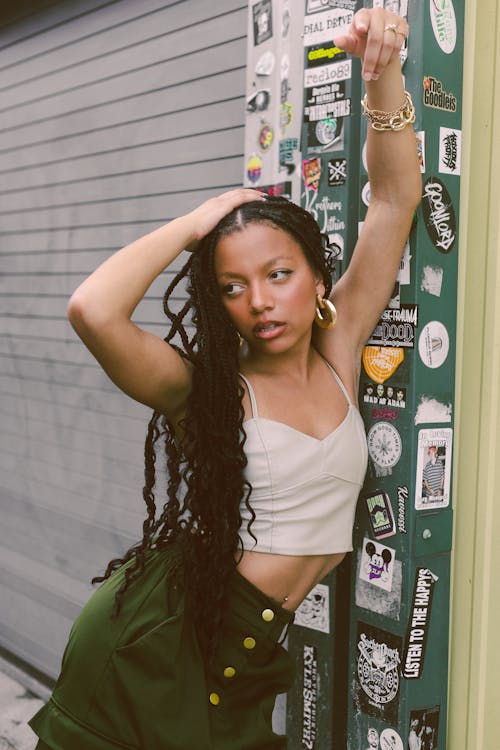 Woman Posing by Wall with Stickers