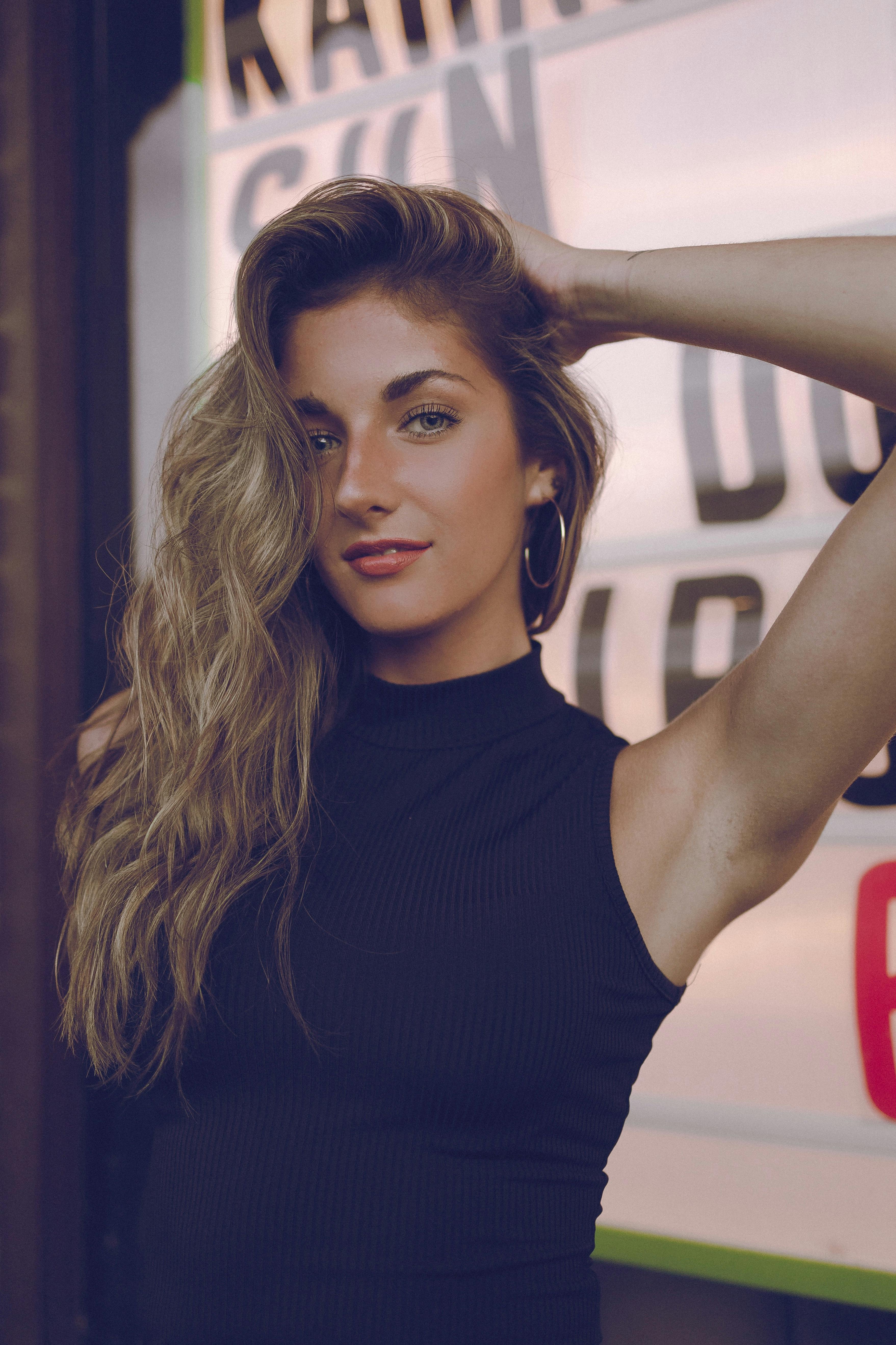 Elegant portrait of a woman posing confidently with a chic urban backdrop.