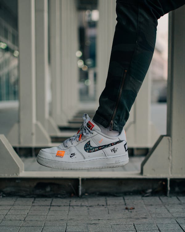 Selective Focus Photography Of Person Wearing Nike Air Force 1 Low Top Shoe