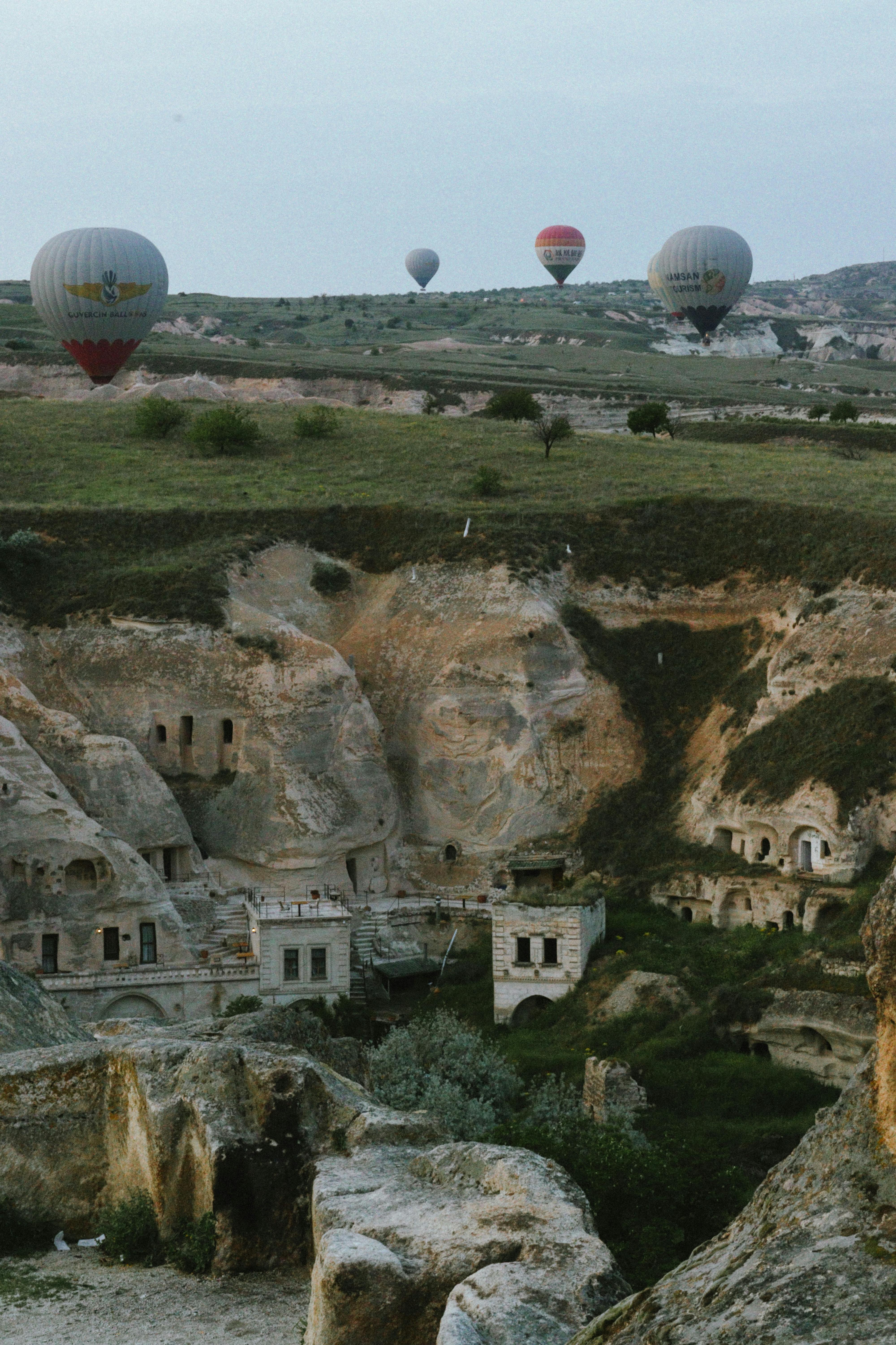 Hot air balloons float over ancient rock formations in Cappadocia, Turkey.