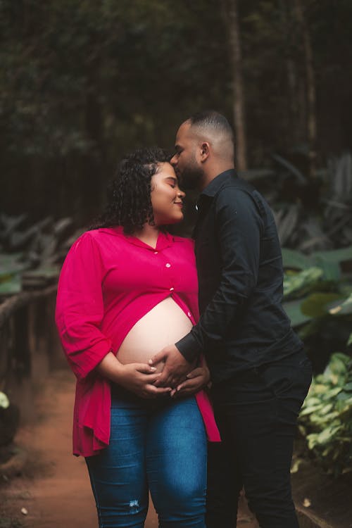 A Couple Expecting a Baby in a Park