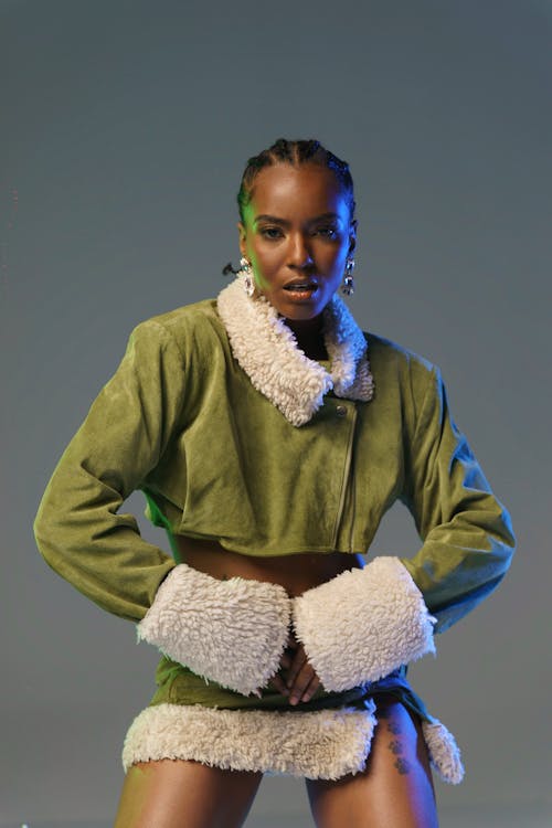 A Model with Braided Hair in a Green Jacket and a Green Mini Skirt