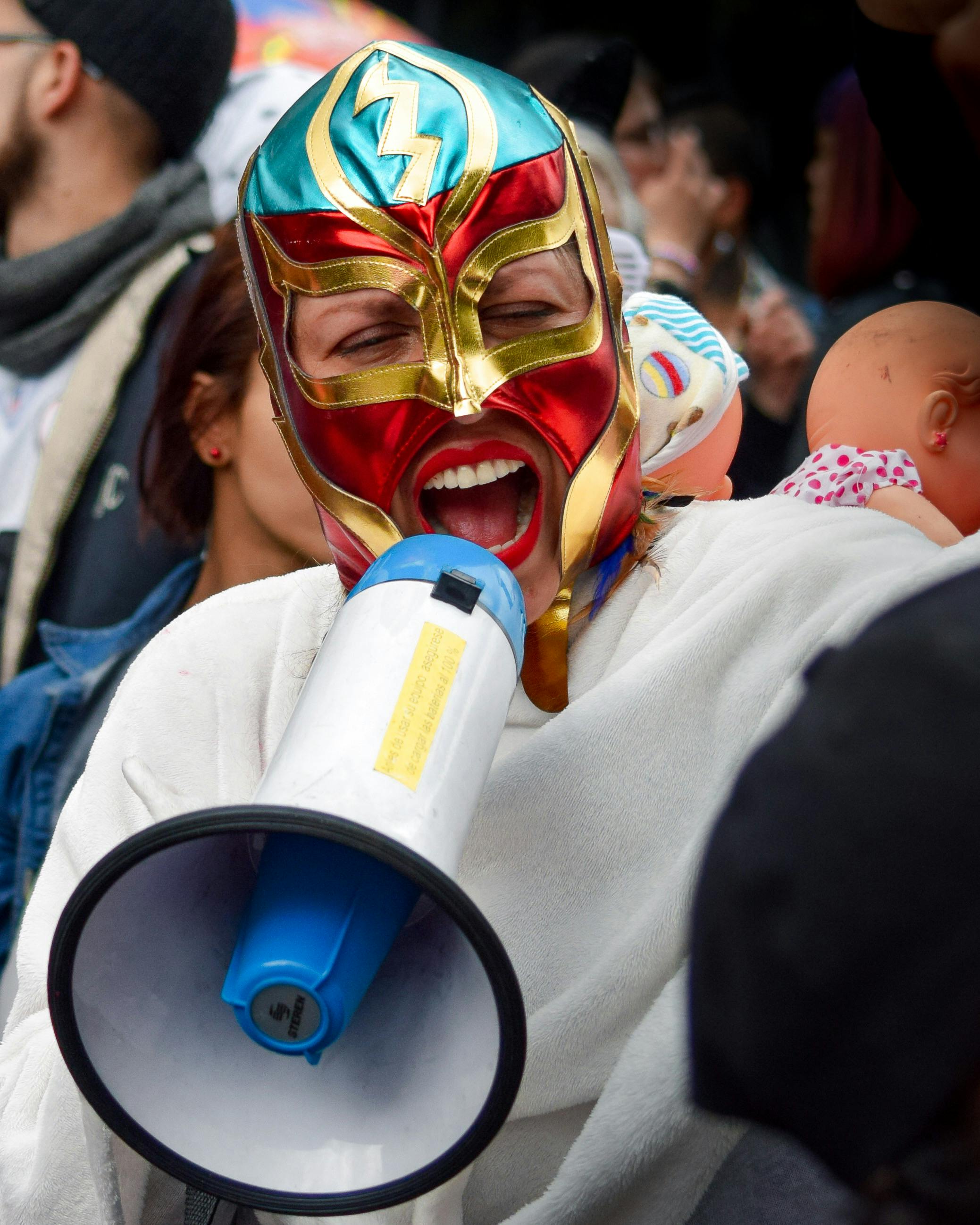 woman wearing a mask shouting on a street