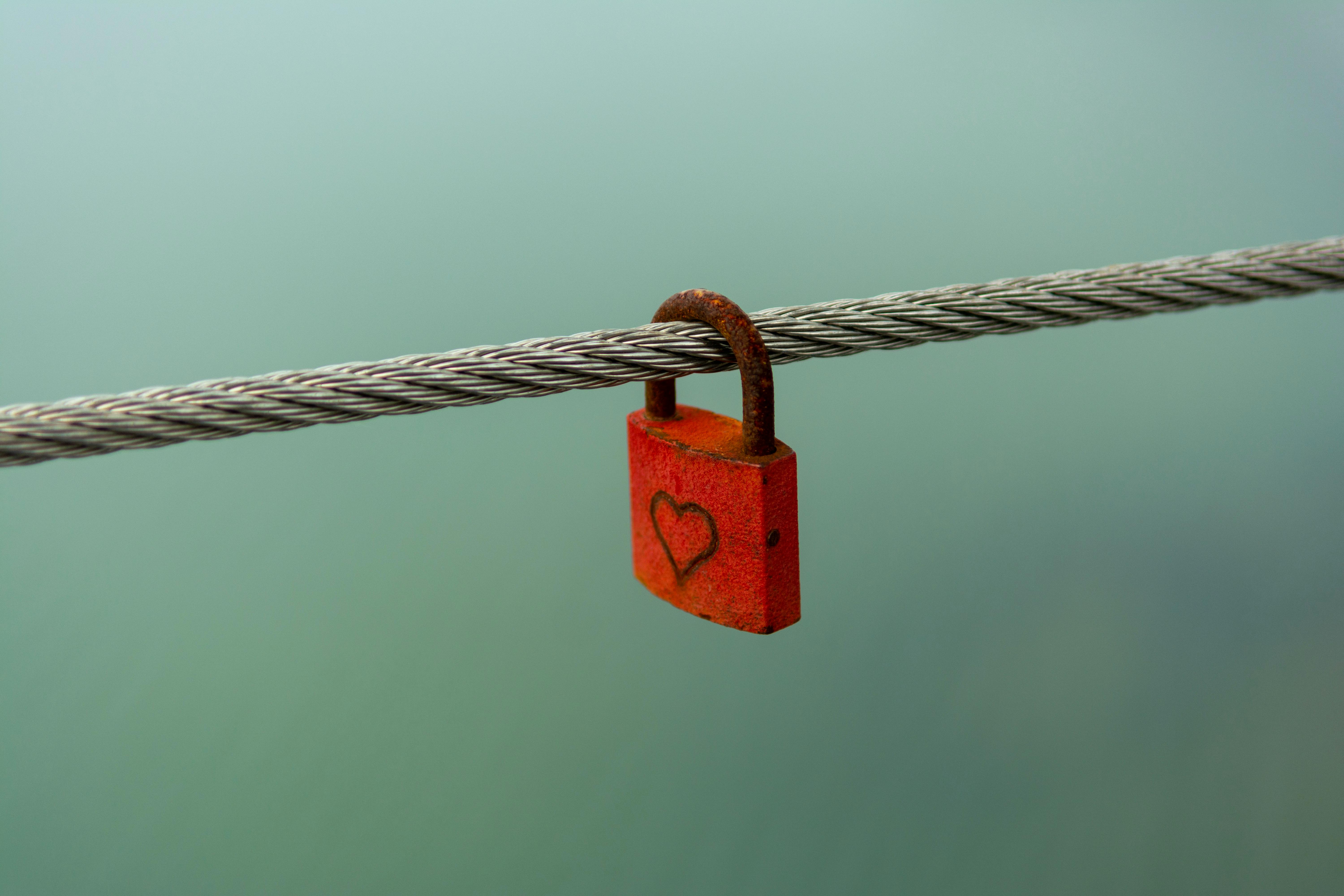 A padlock on a wire with a heart on it