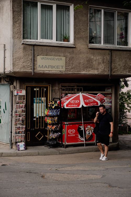 Free A man walks past Vatansever Market in a busy Turkish street. Stock Photo