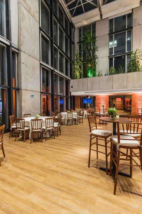 Free A spacious, elegant restaurant interior with wooden flooring and furniture, ready for guests. Stock Photo
