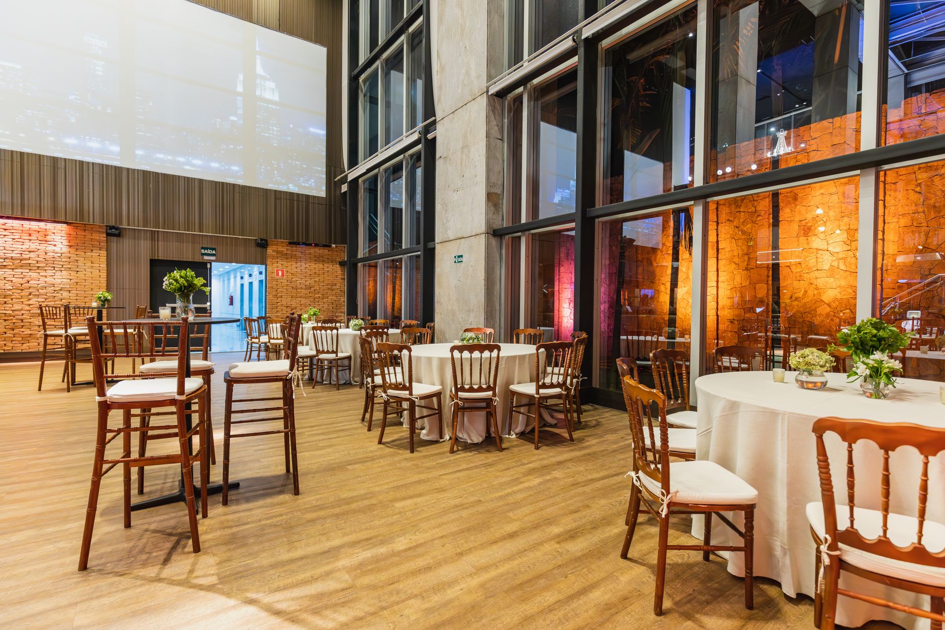 Stylish indoor venue with elegant round tables and chairs, perfect for celebrations.