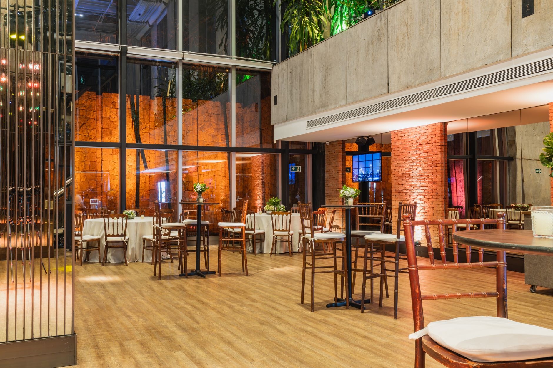 Spacious and modern event venue with elegant decor and natural lighting, perfect for gatherings.