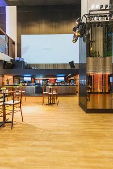 Spacious and elegant event venue featuring a stylish bar setup and modern furniture.