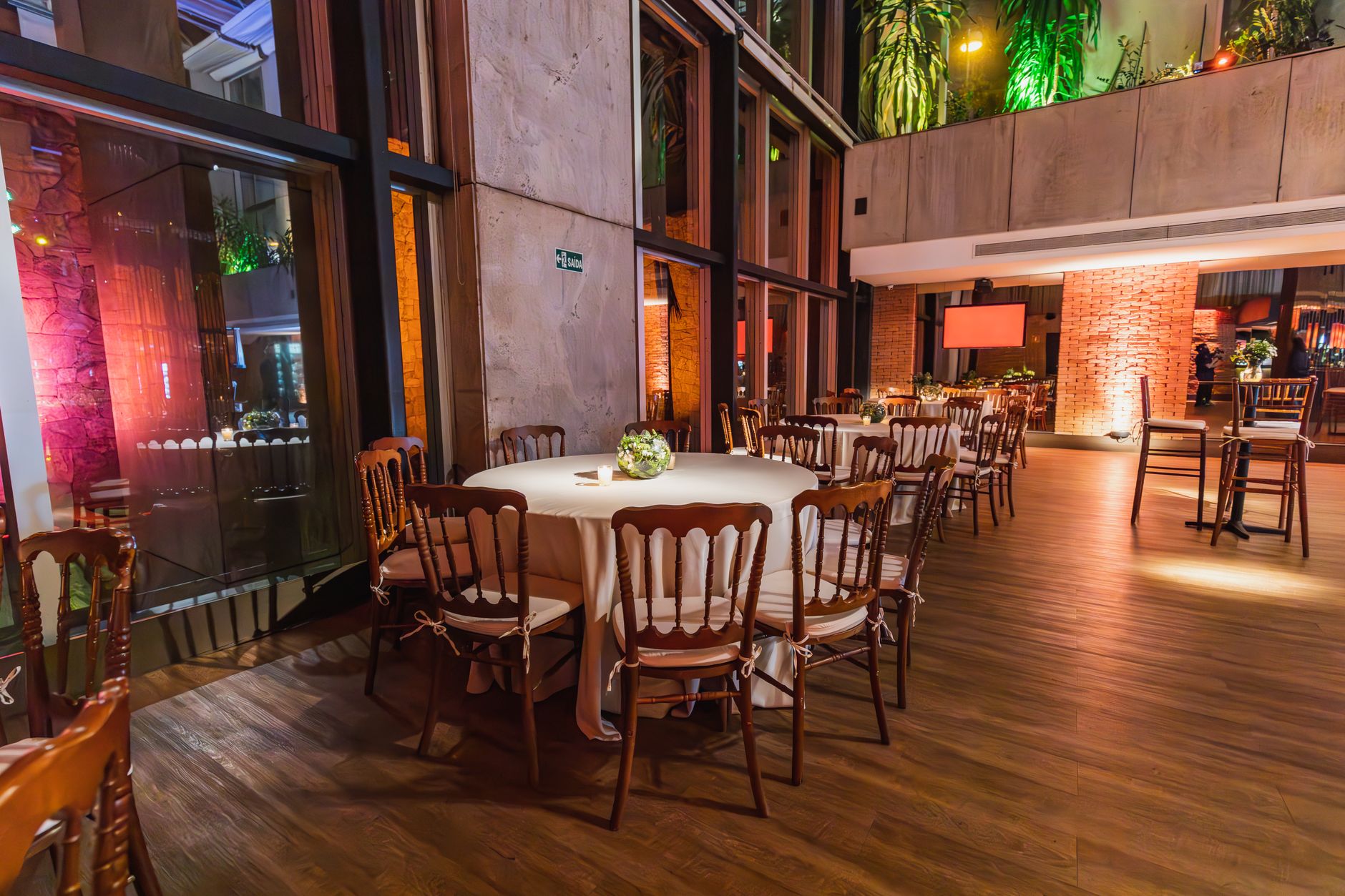Luxurious indoor dining setup with elegantly decorated tables and chairs for a formal event.