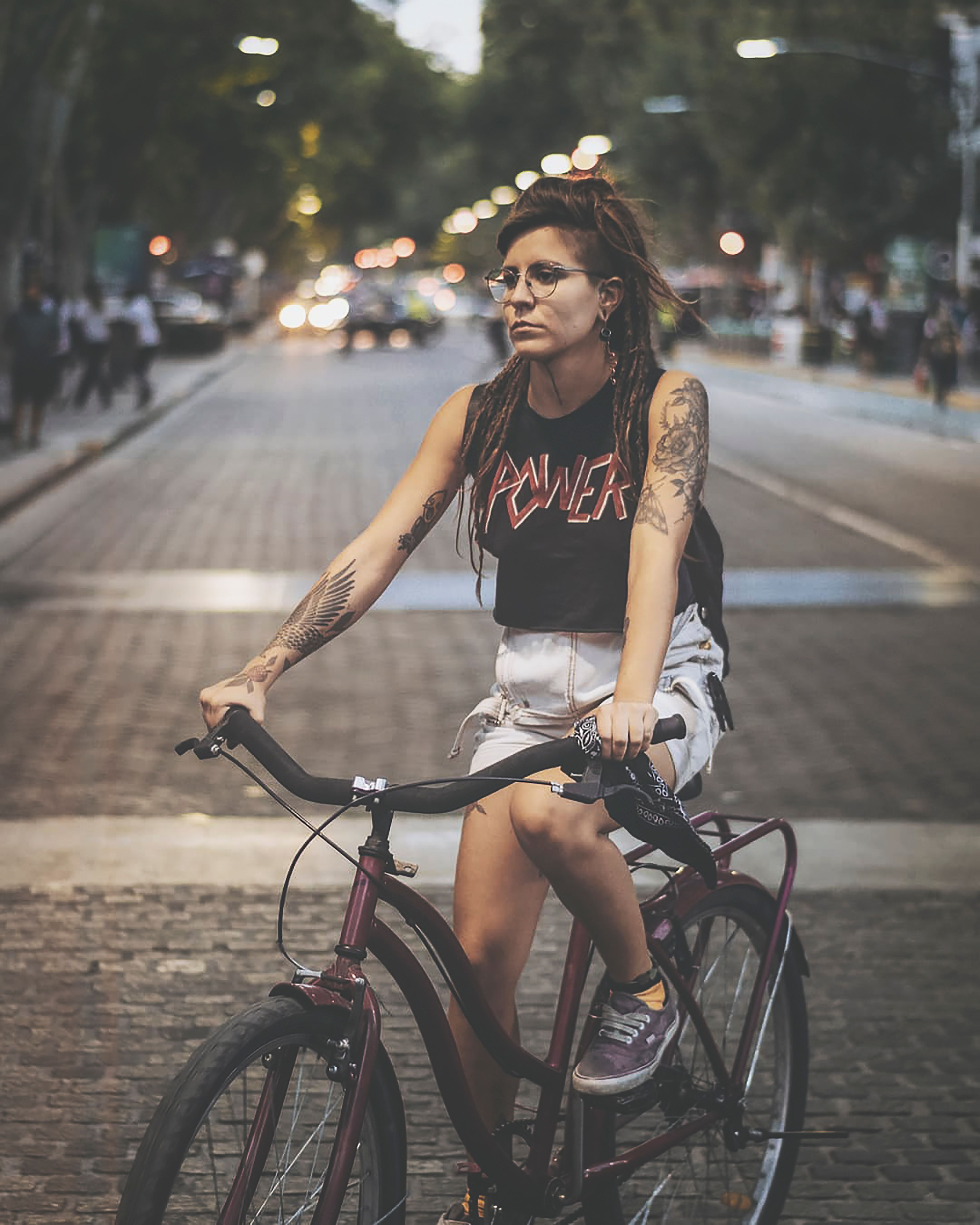 Woman with Tattoos on Bike · Free Stock Photo