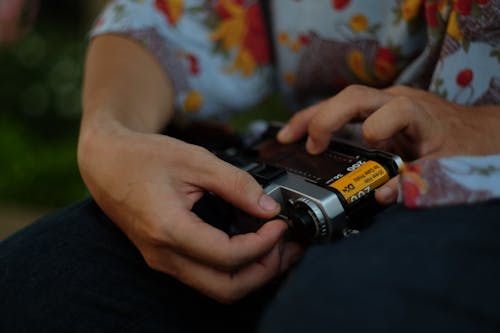 Close-up of a Man Holding a Film Camera 