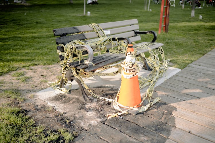 A Bench Wrapped In A Caution Tape 