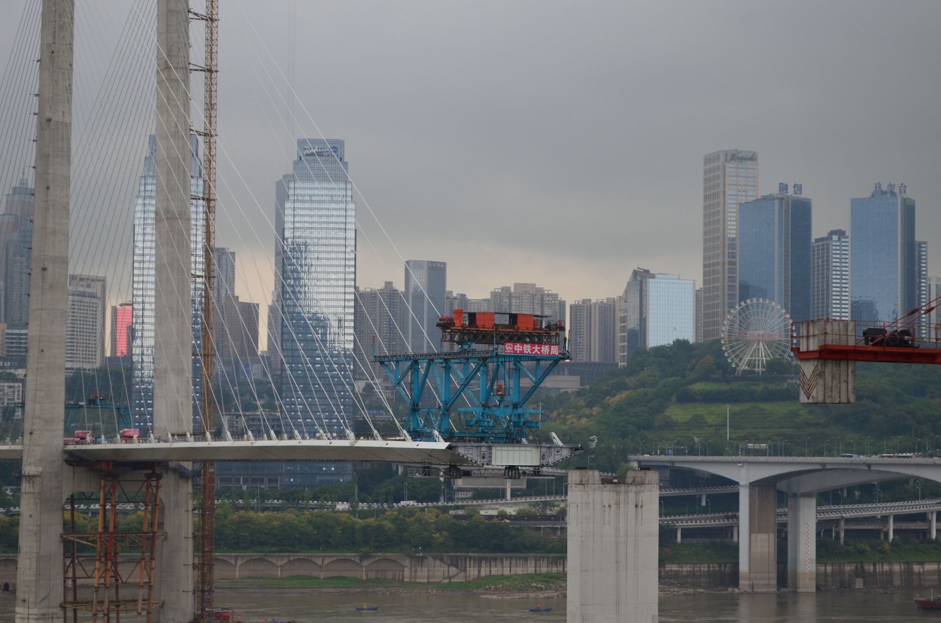 View of a Modern City and a Suspension Bridge under Construction