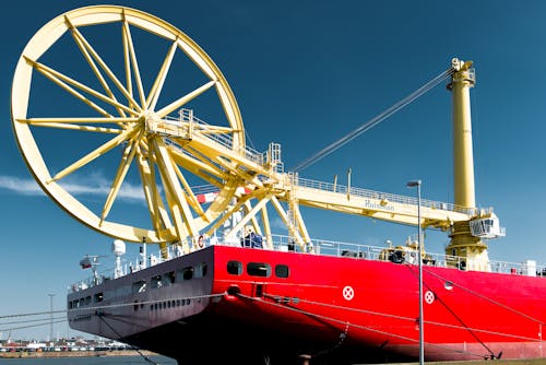 Huge Wheel over Cargo Ship in Harbor
