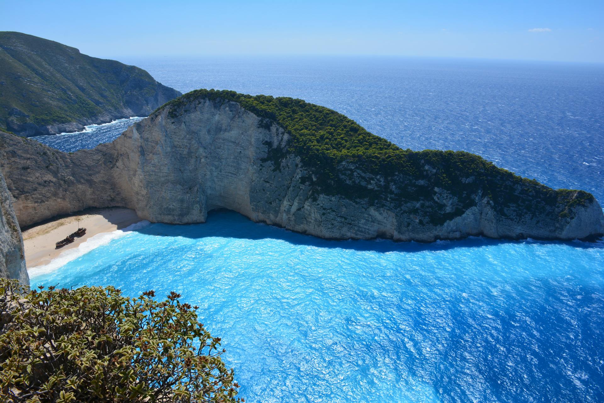 Breathtaking aerial shot of Navagio Beach's turquoise waters and limestone cliffs on Zakynthos Island.