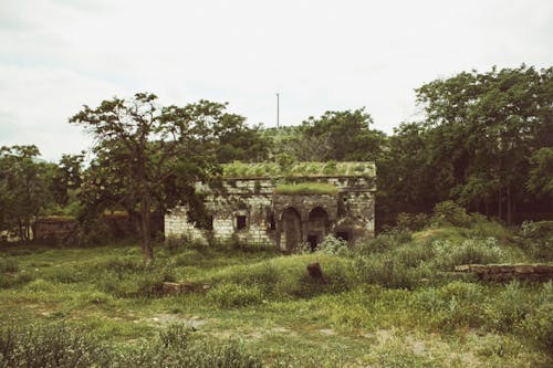 An old building in the middle of a field