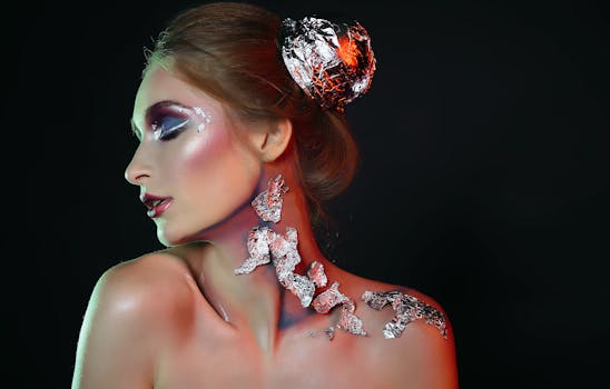 Creative portrait featuring a woman with metallic makeup and foil accents on skin and hair.