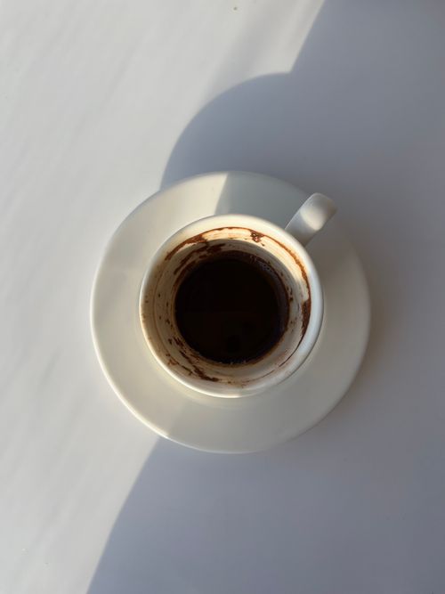 Free Detailed shot of an empty coffee cup with stains on a white saucer. Stock Photo
