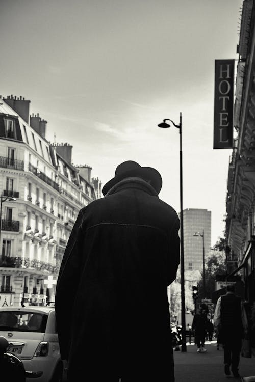 Back of a Person Wearing a Coat Standing on the Street