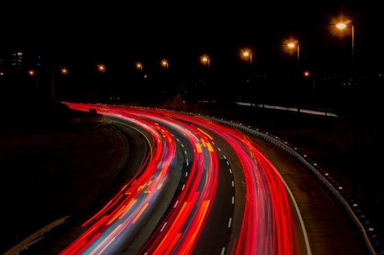 Long-exposure light trails along a highway at night — photo by Mian Rizwan on Pexels