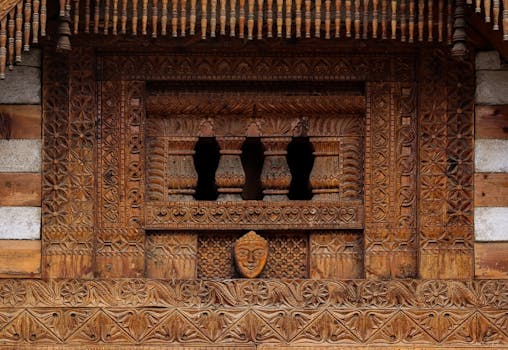 Detailed wooden carving on a traditional Indian temple facade, showcasing ancient architecture.